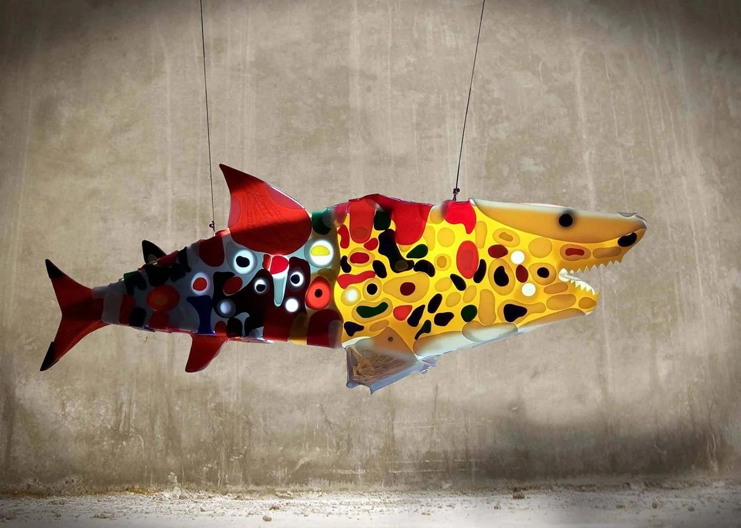 Renegade is a shark sculpture in orange and red colors.