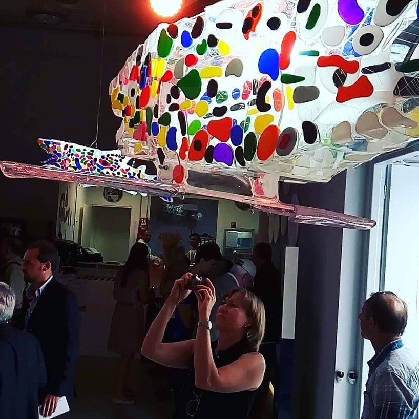 Photo from the exhibition in Milan with shark sculptures.